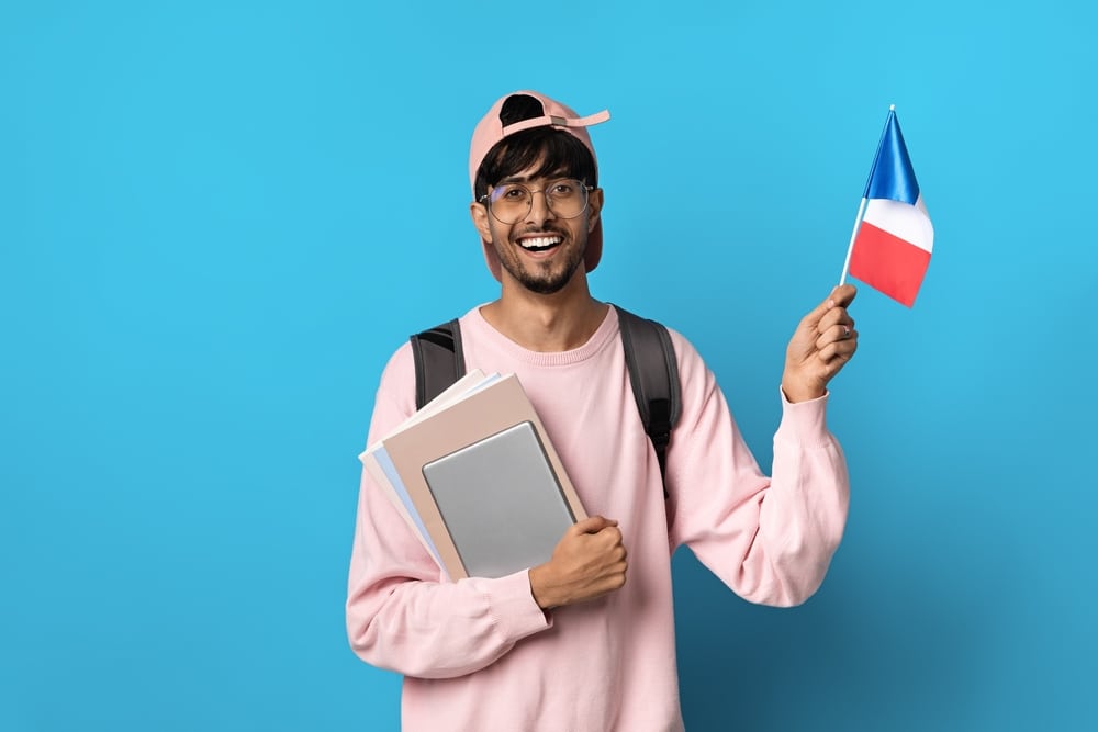 french student holding a flag