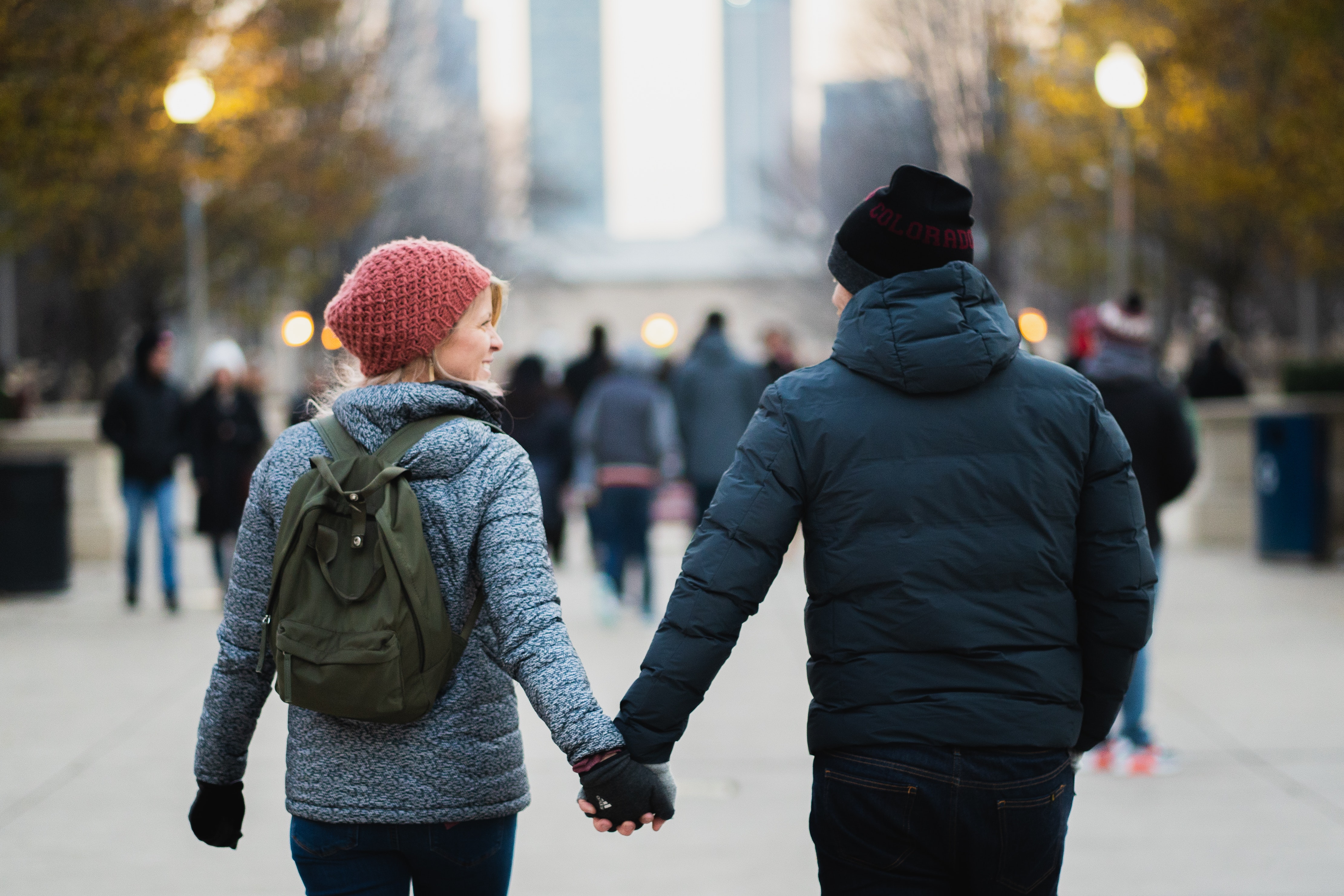 man-and-woman-holding-hands-while-walking-at-the-park