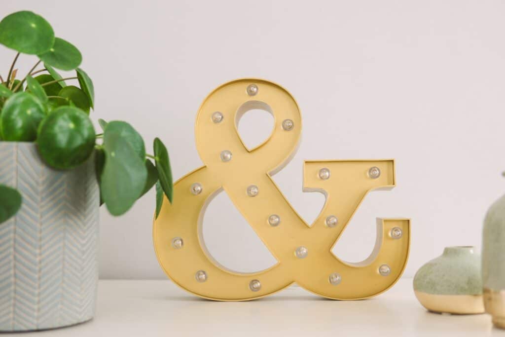 an image of the ampersand decoration standing on the table next to the wall