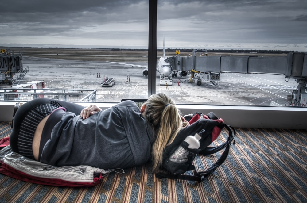 exhausted female traveller laying on the floor