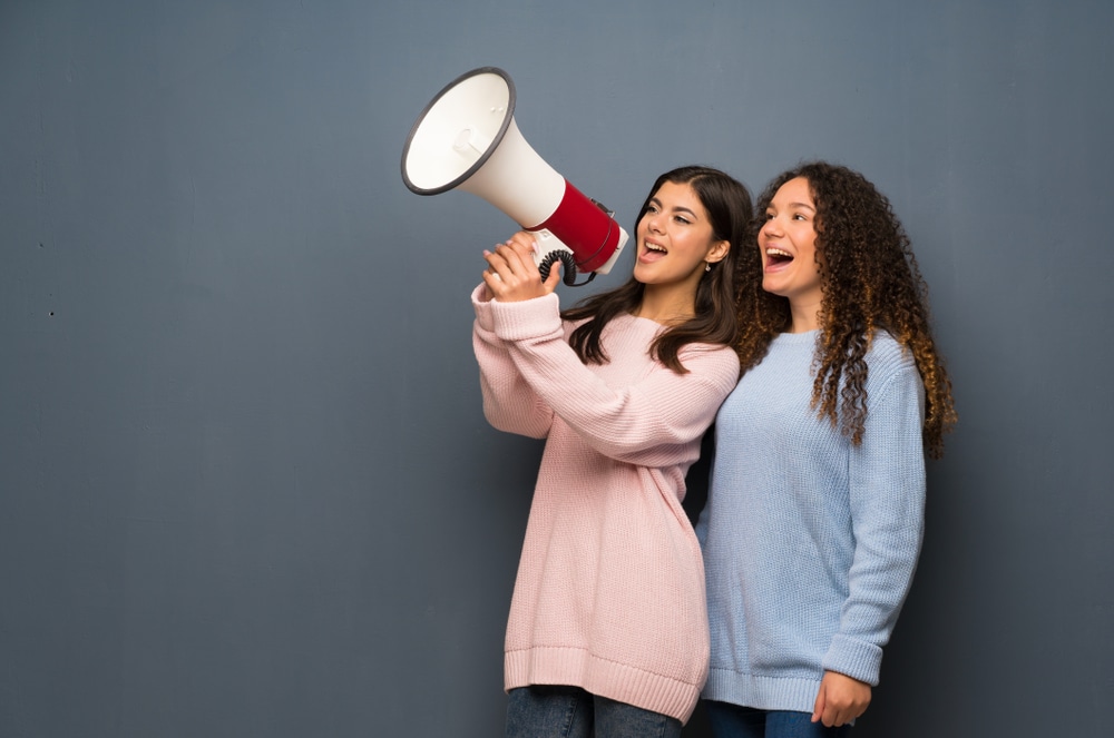 teenagers speaking into a megaphone