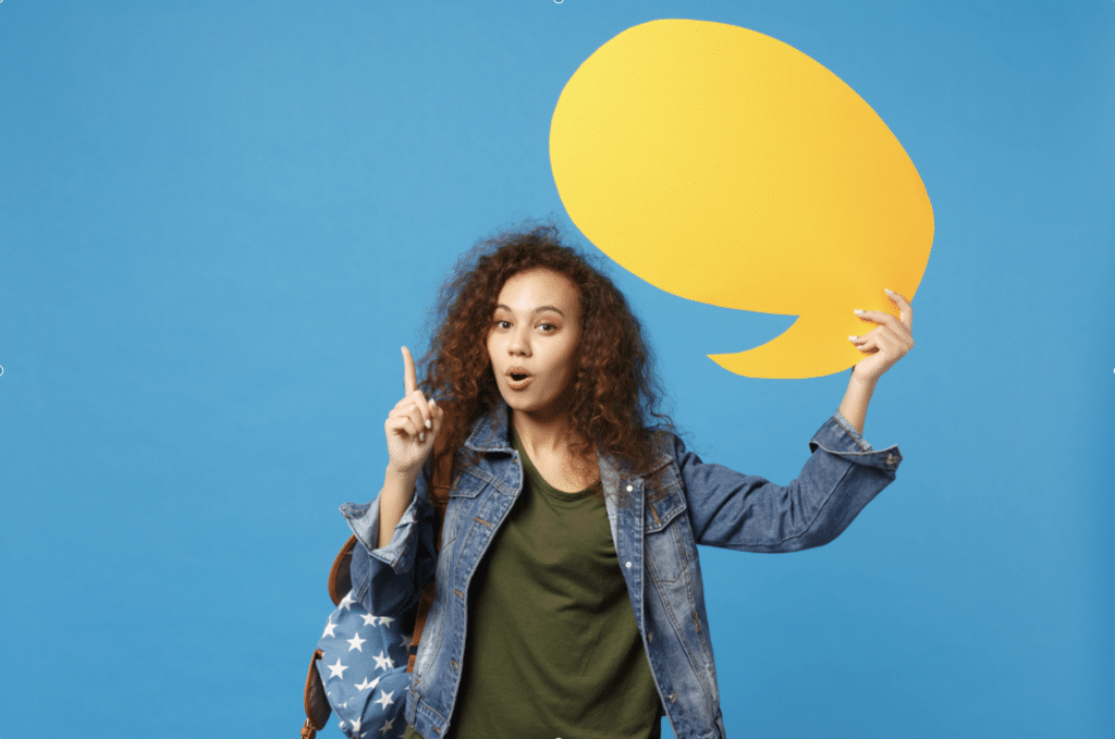 girl holding a speech bubble, signifying a a french oral exam