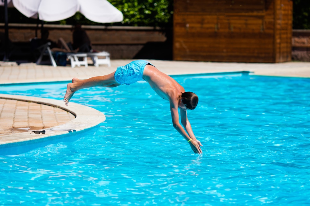 boy-jumping-into-pool
