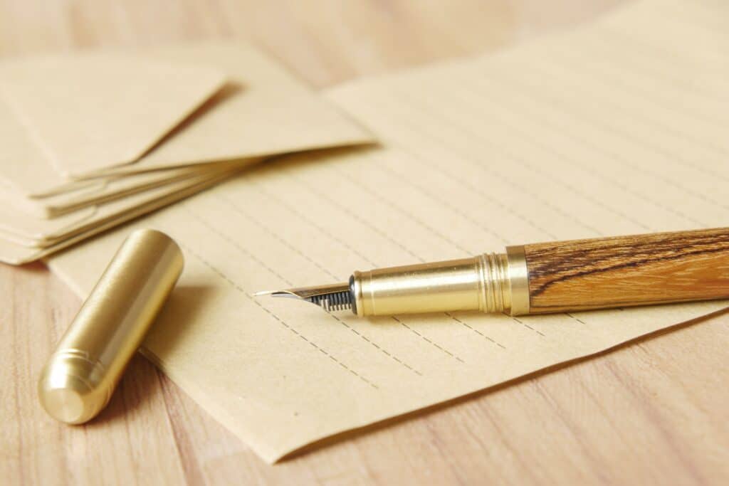 fountain-pen-and-paper-in-gold-color-scheme