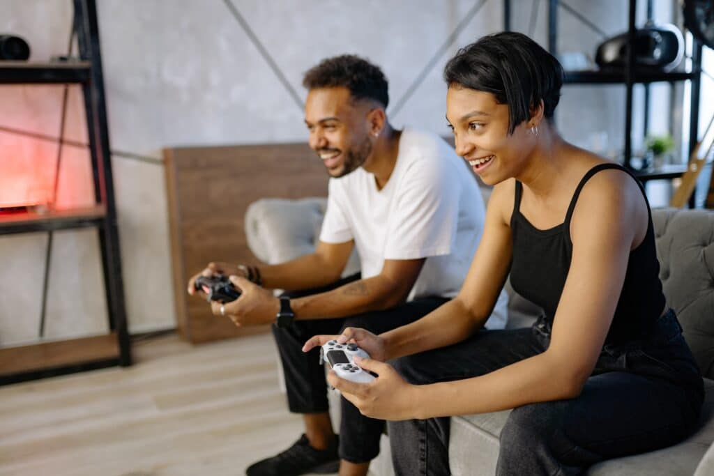 man-and-woman-couple-play-video-games-on-a-couch