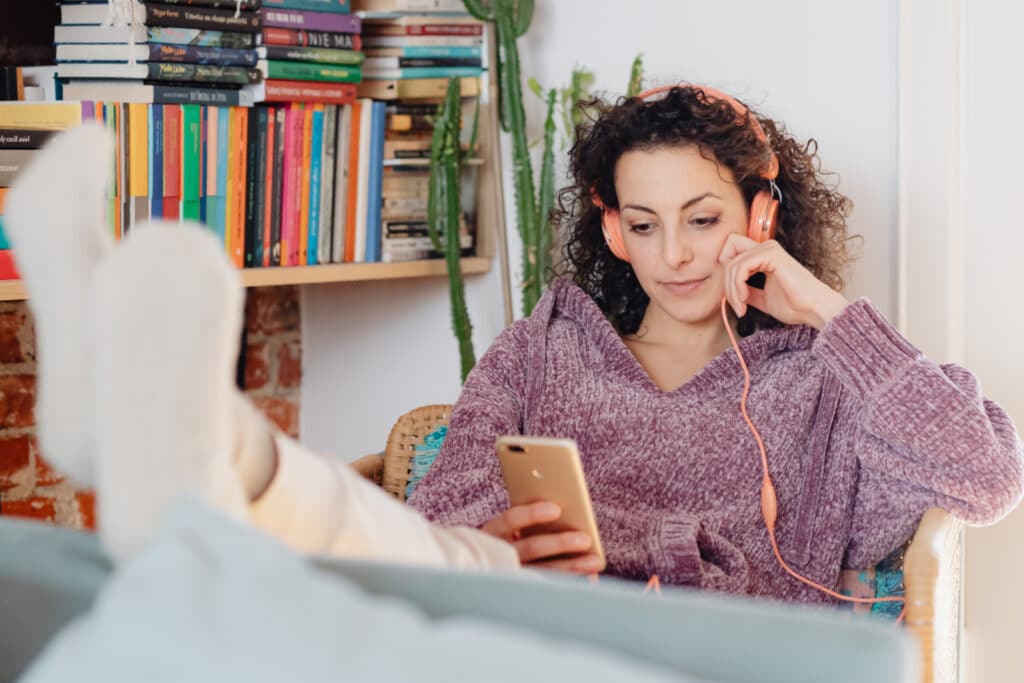 Woman listening to headphones with feet up