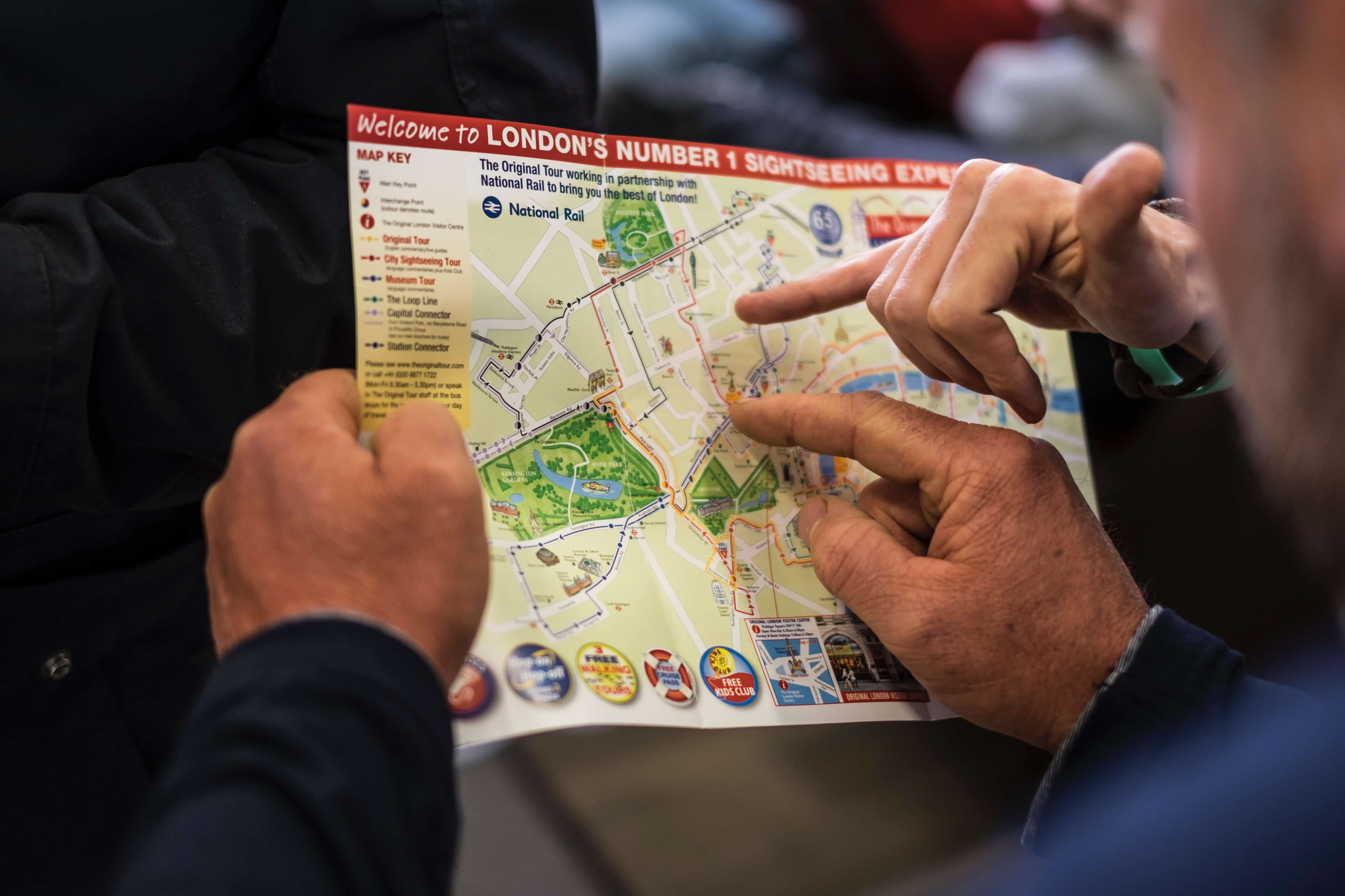 A person gives directions using a map