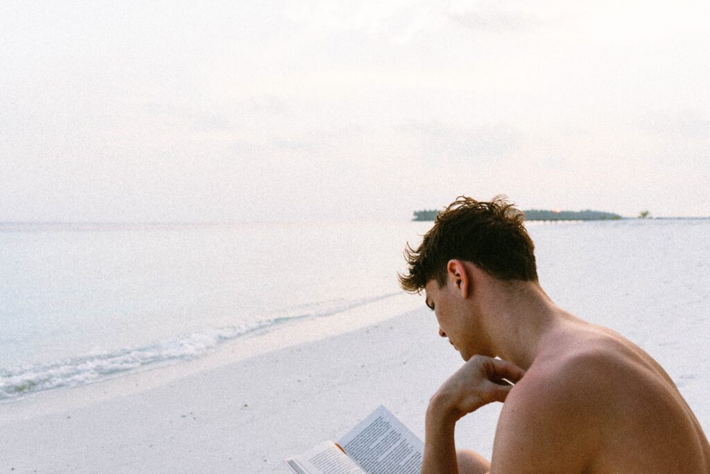 A man reading on the beach