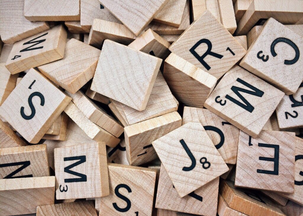 close-up-photo-of-a-pile-of-small-wooden-letters-scrabble