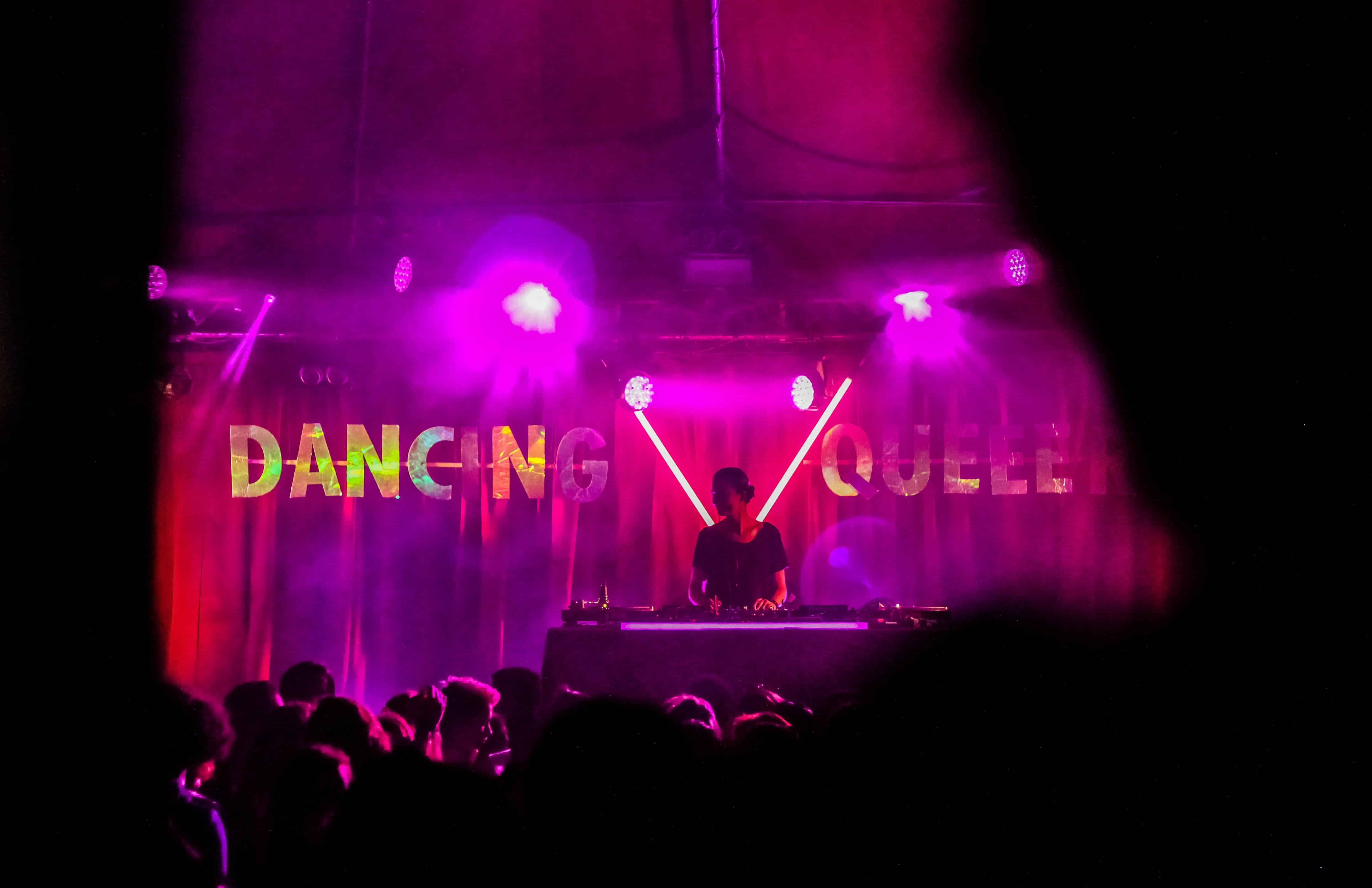 A DJ plays on a stage