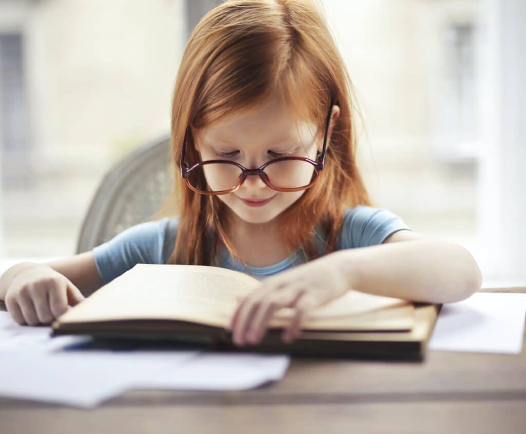 young-girl-with-big-glasses-reading-book