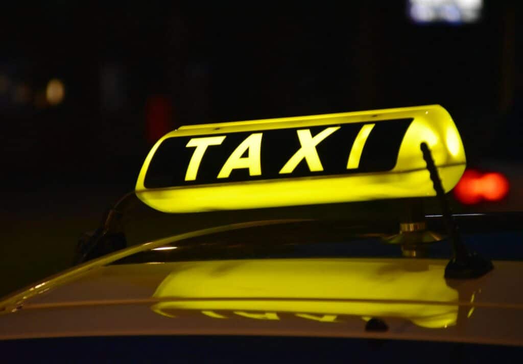 close-up-of-glowing-taxi-sign-against-dark-background
