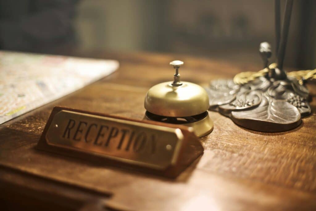 close-up-of-plaque-saying-reception-and-antique-hotel-bell