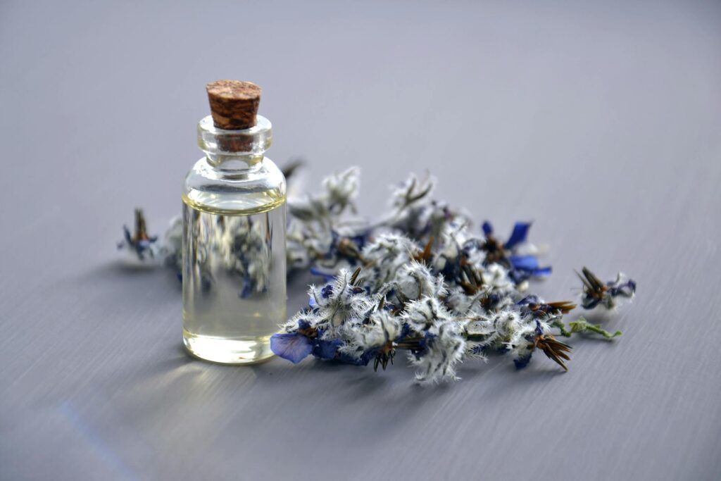 bottle-with-cork-lid-beside-blue-flowers