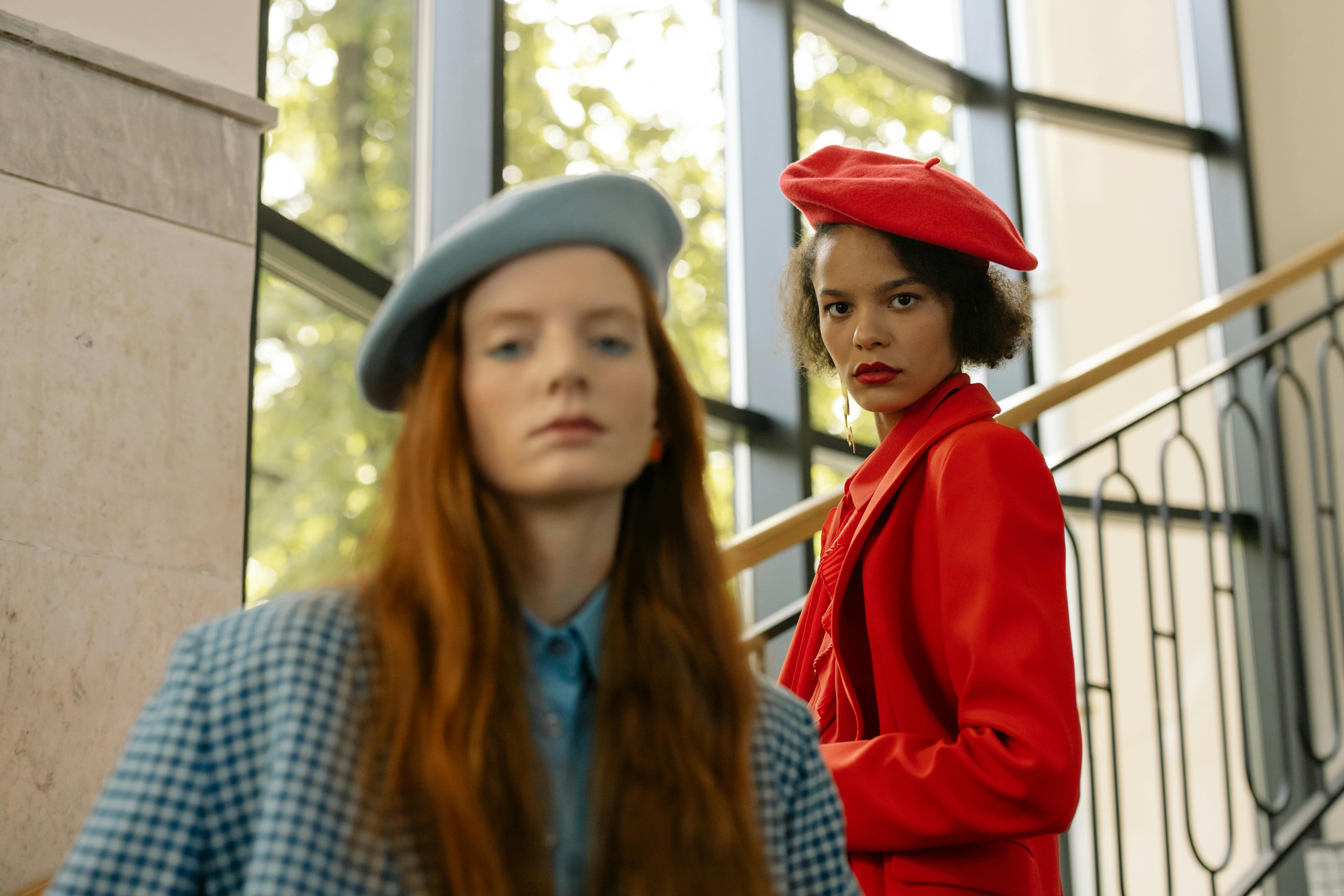 Two women pose in berets in French national colors