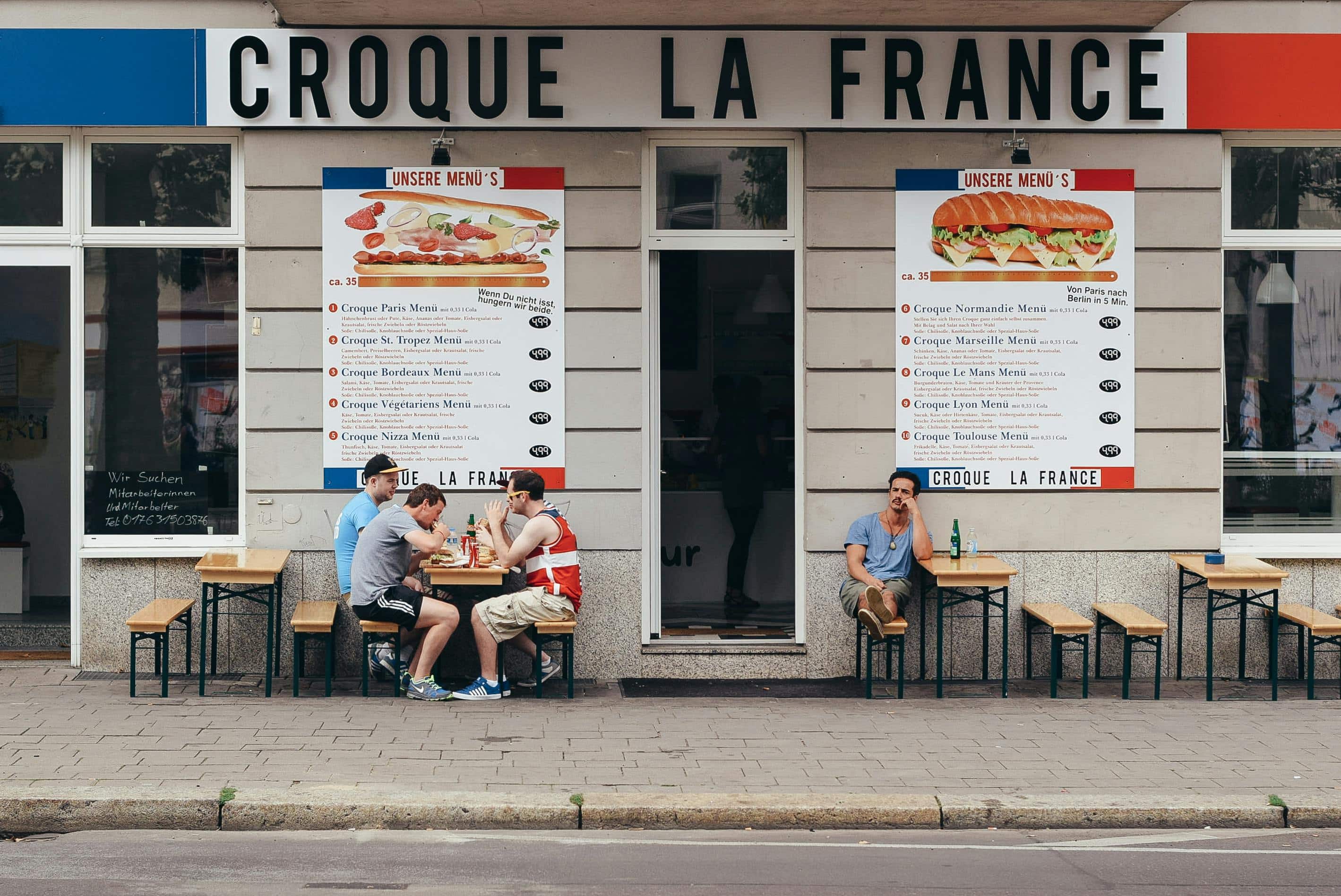 People dining in front of a French restaurant