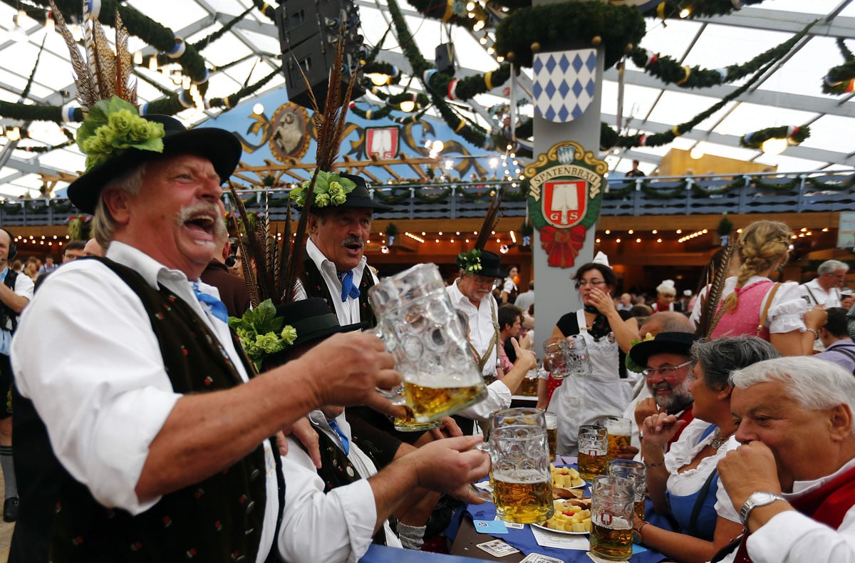 Revellers salute with beer at the Oktoberfest in Munich