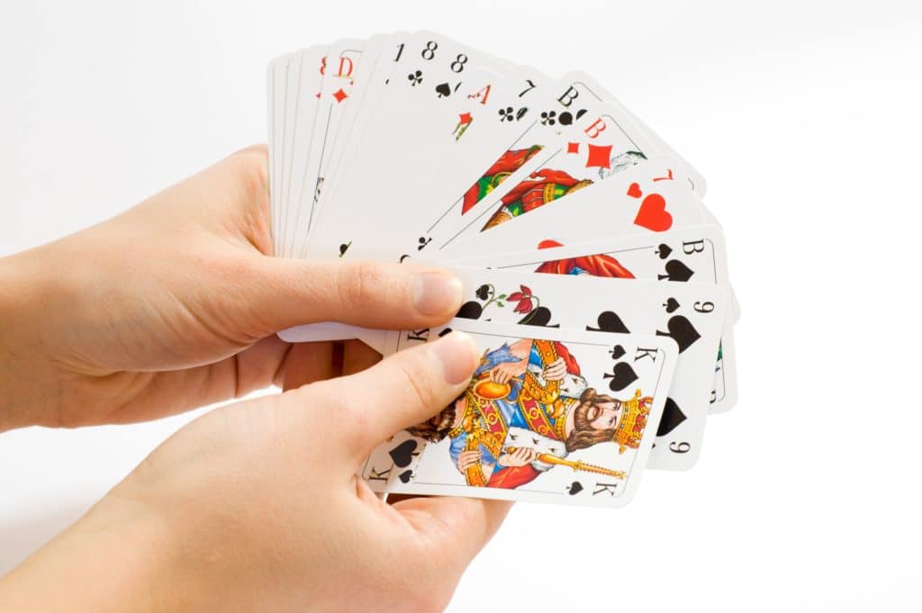 Hands holding playing cards