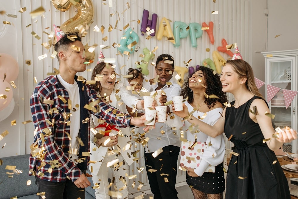 adults-at-a-birthday-party-with-golden-confetti-falling-down