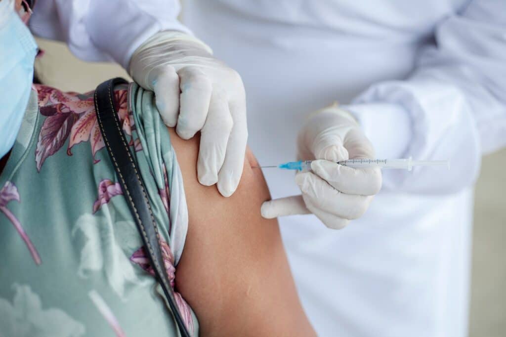 woman getting vaccine from nurse