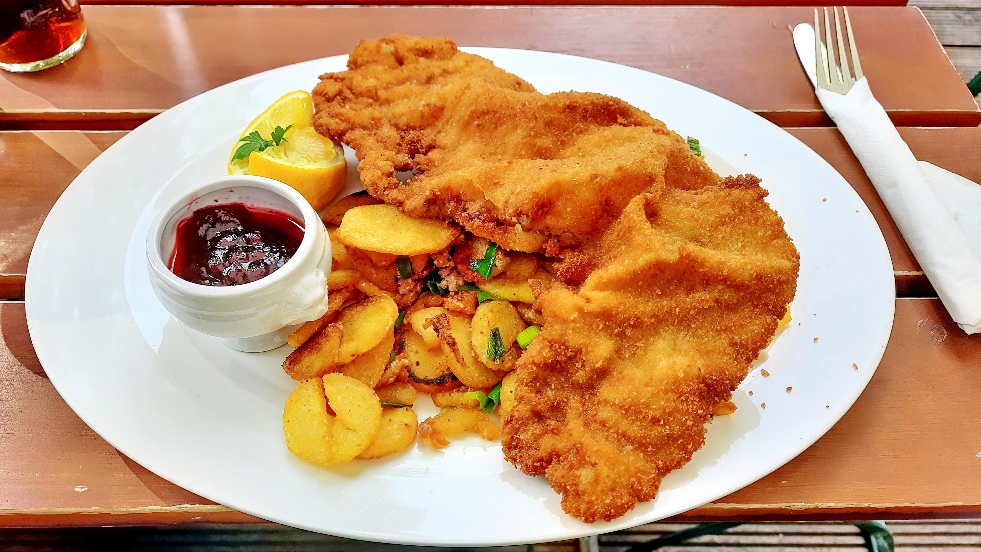 Schnitzel with pommes on a plate.