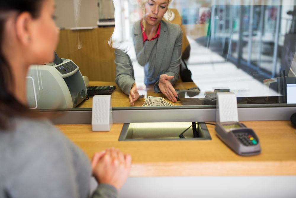 bank-teller-giving-cash-to-customer