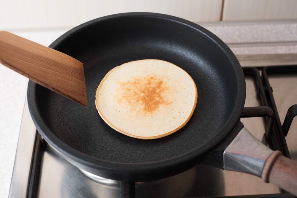 pancake-in-pan-with-wooden-spatula