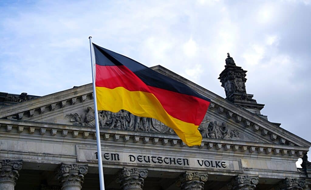 The German flag flying in front of a government building