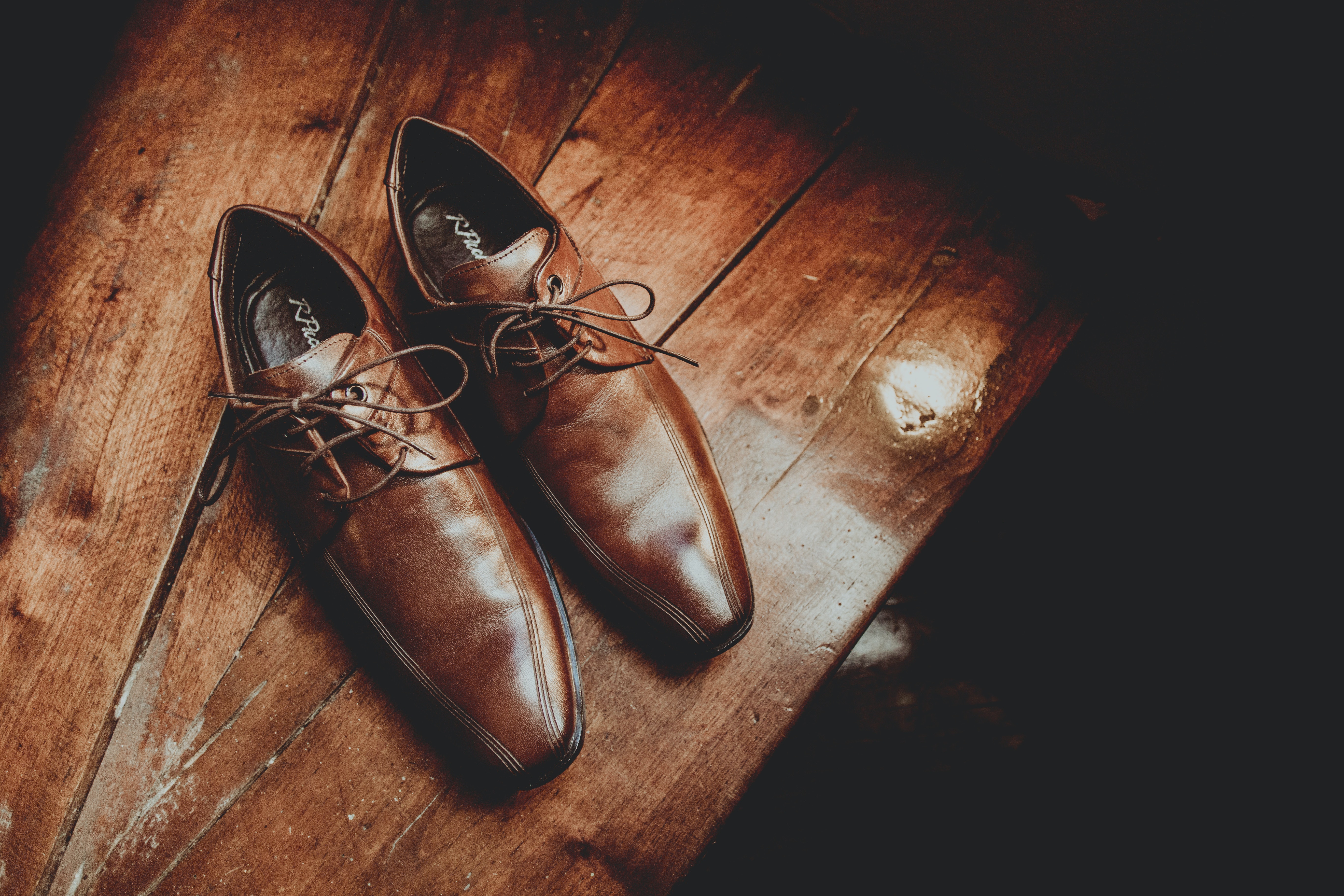 elegant-brown-leather-shoes-on-wooden-surface