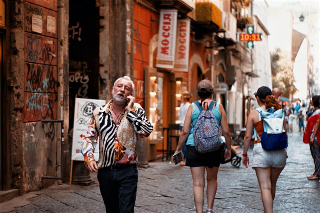Man talking on phone on Naples street