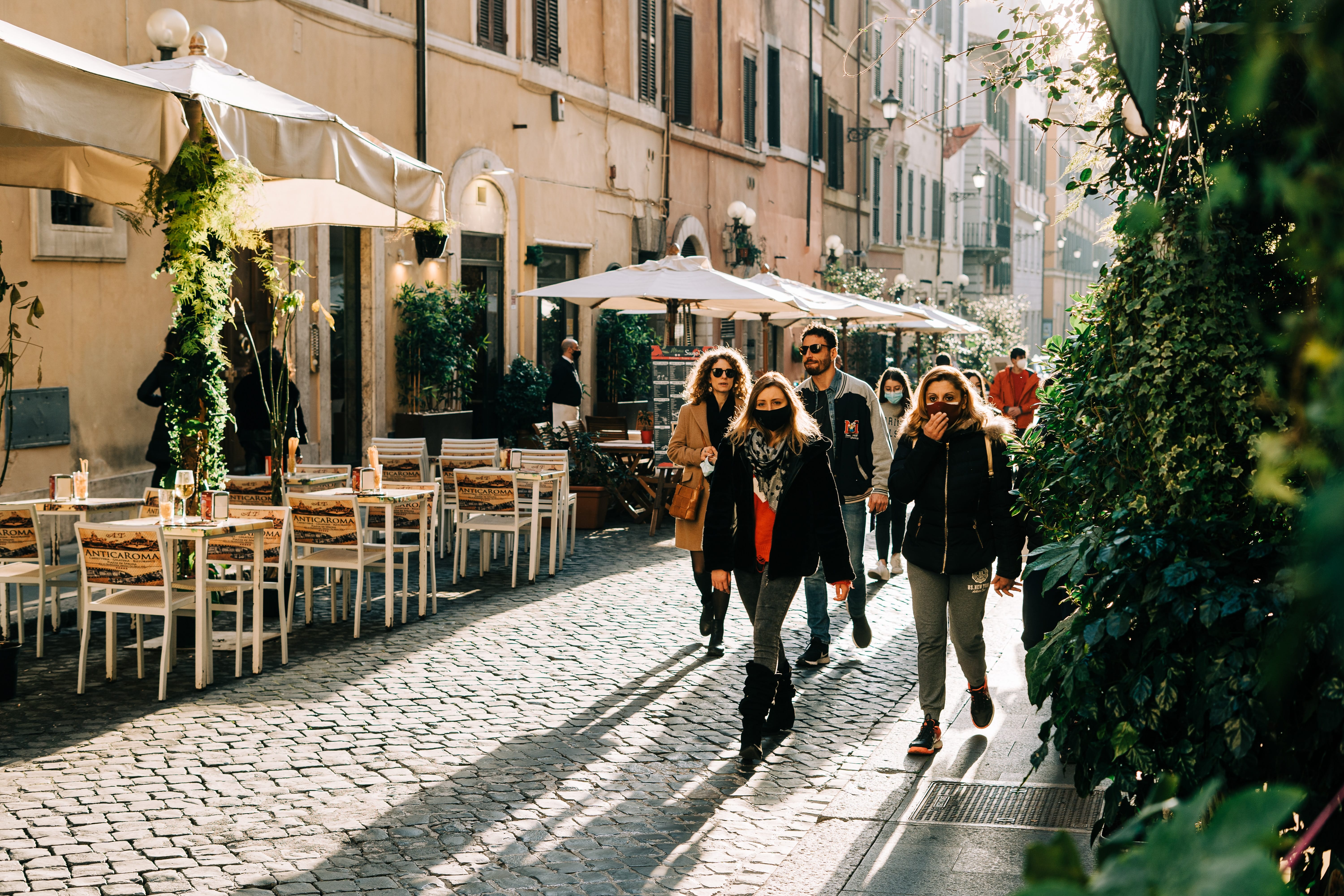 People walking past a cafe in Rome