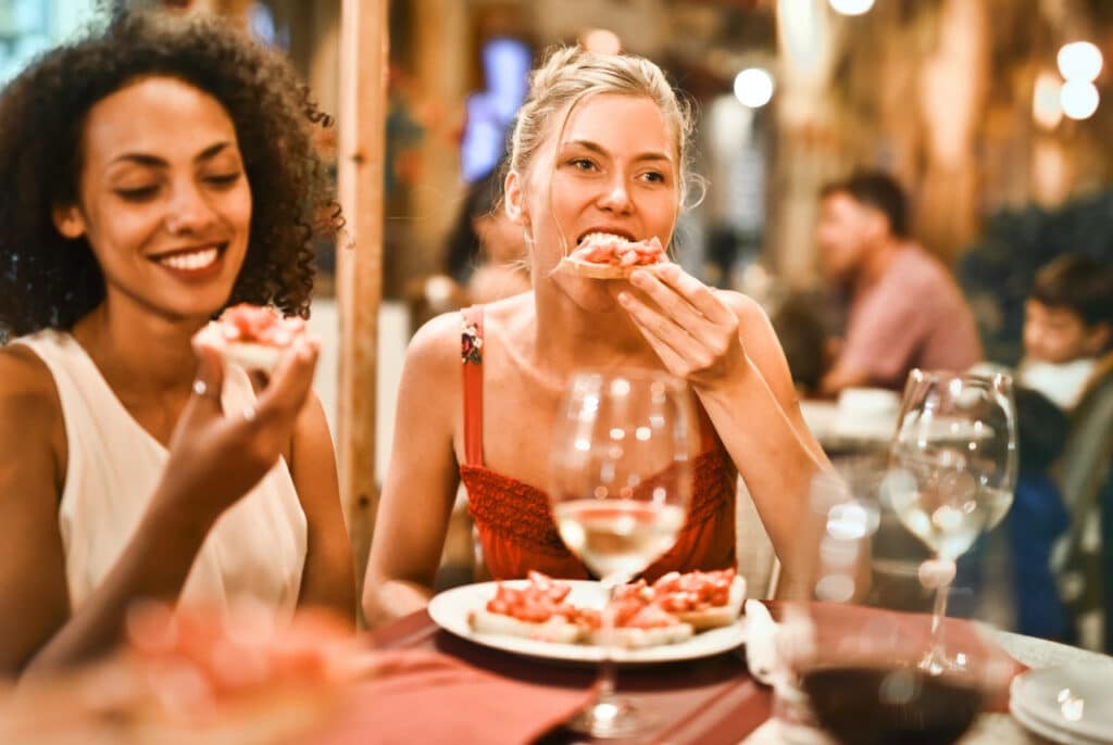 Women eating pizza in Italy