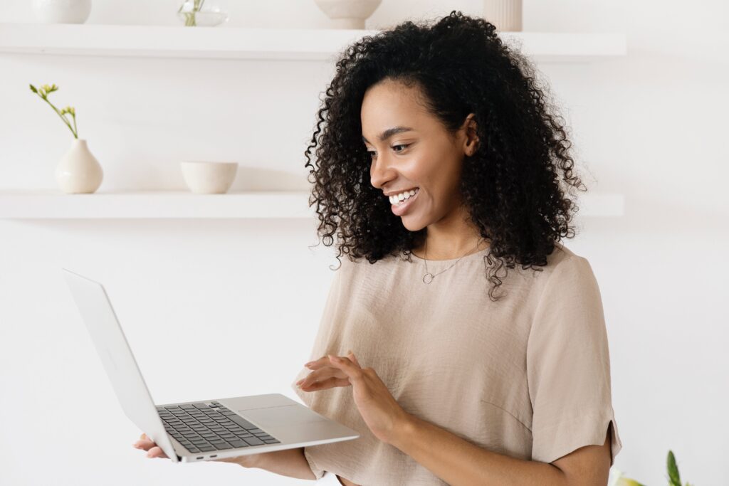 a-woman-using-a-laptop-smiling