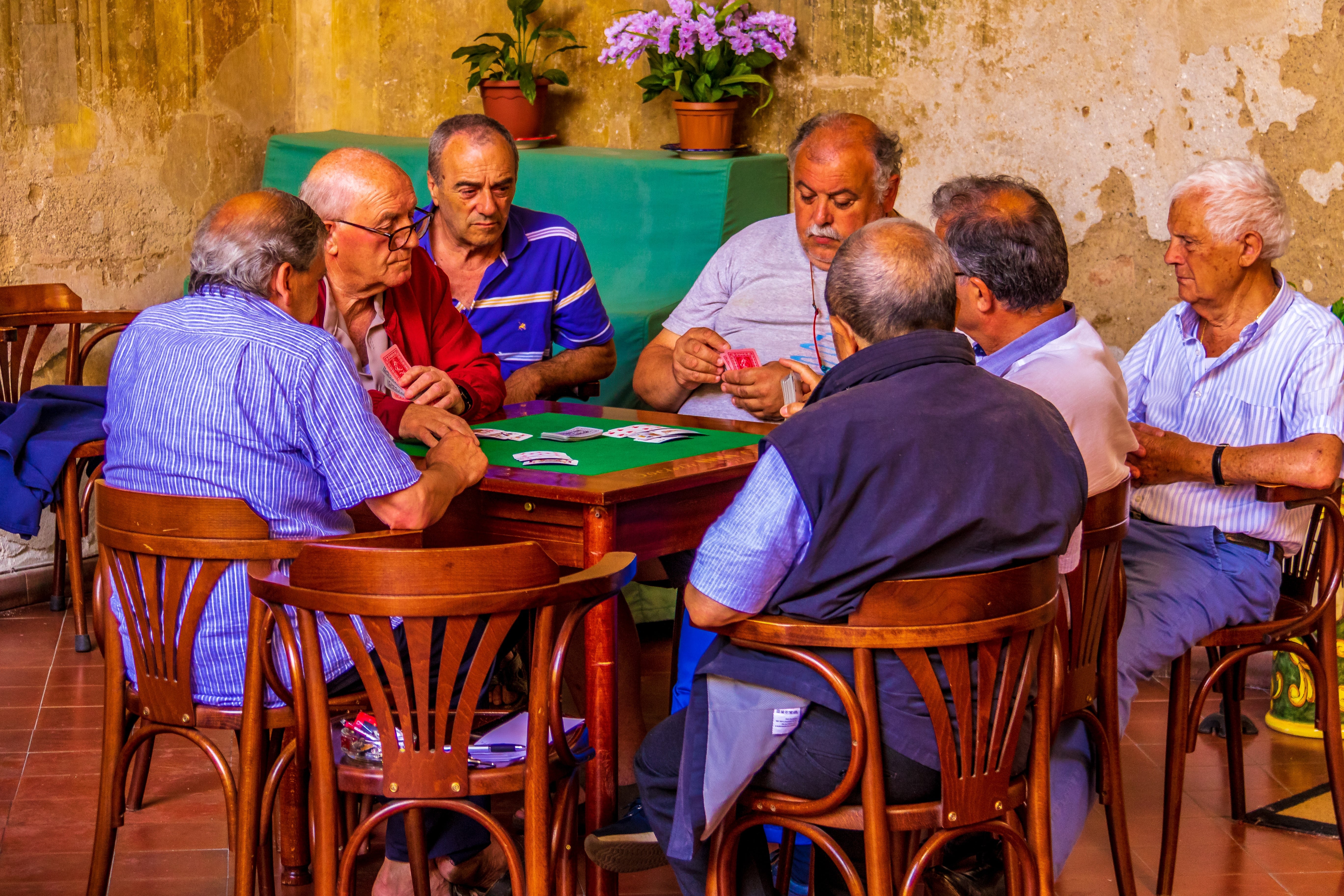 Men sit around playing a game in Naples, Italy