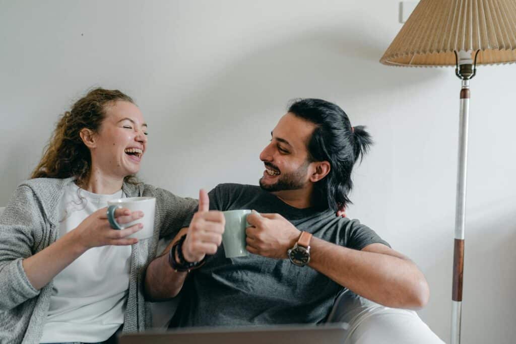 woman-and-man-having-coffee-together-and-smiling-laughing