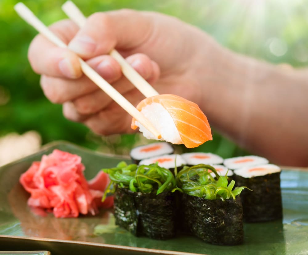 close-up-of-chopsticks-picking-up-sushi