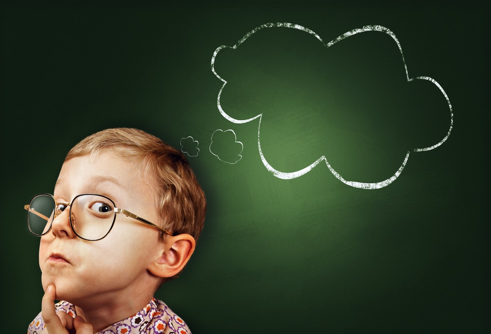 a kid in glasses with a thinking face and a speech bubble next to him