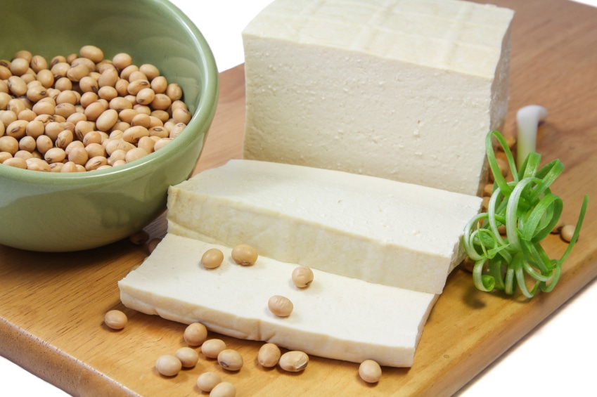Tofu block pictured with soybeans