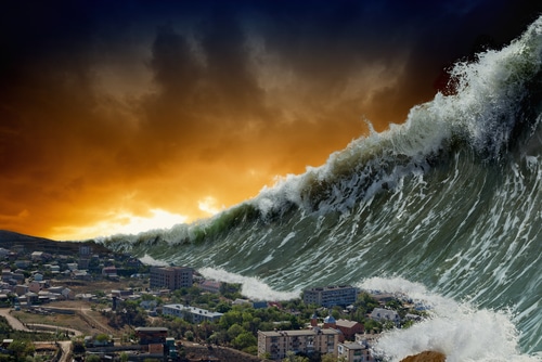 Tsunami tidal wave rearing over a city