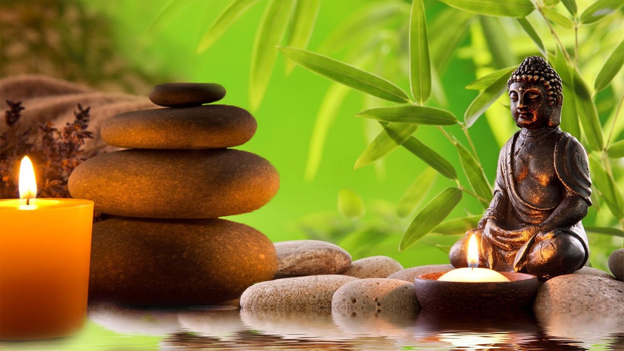 Zen meditation paraphernalia, including stones, candles, and Buddha figure
