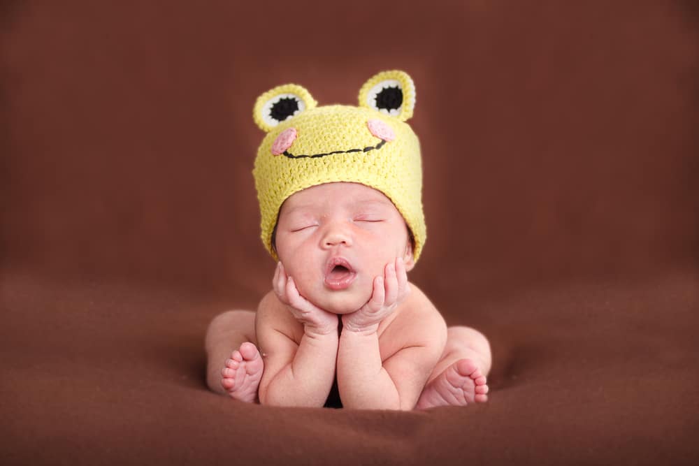 Baby with frog hat