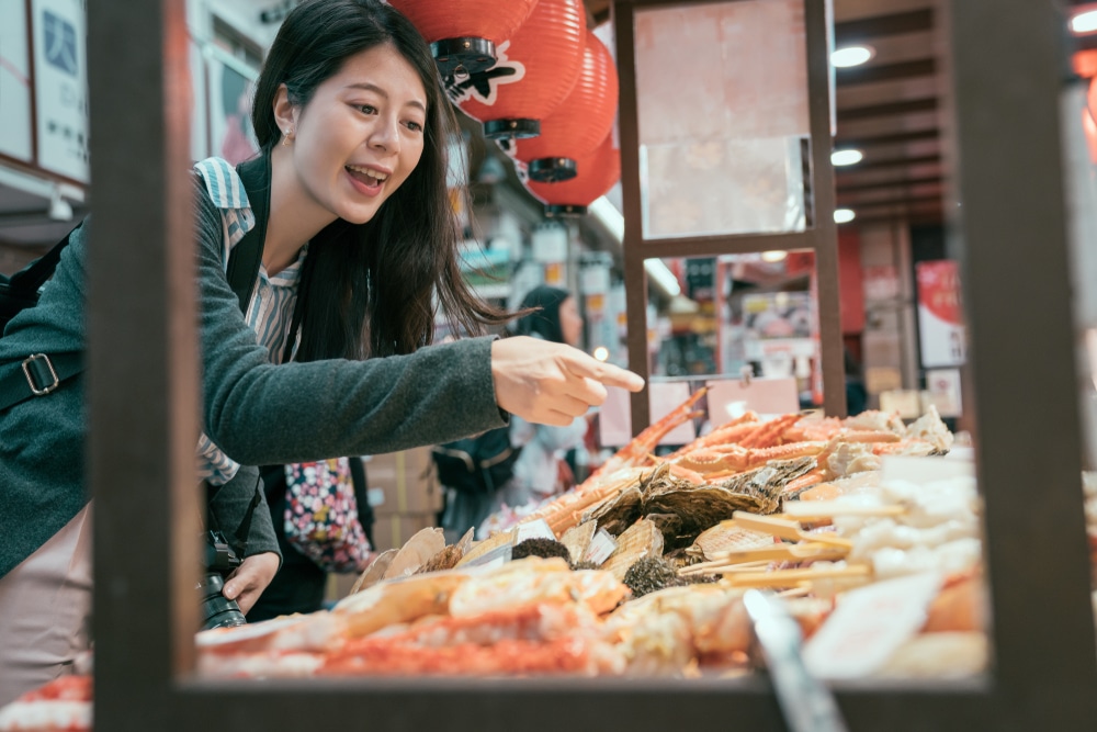 Japanese lady pointing out an item at a Japanese market