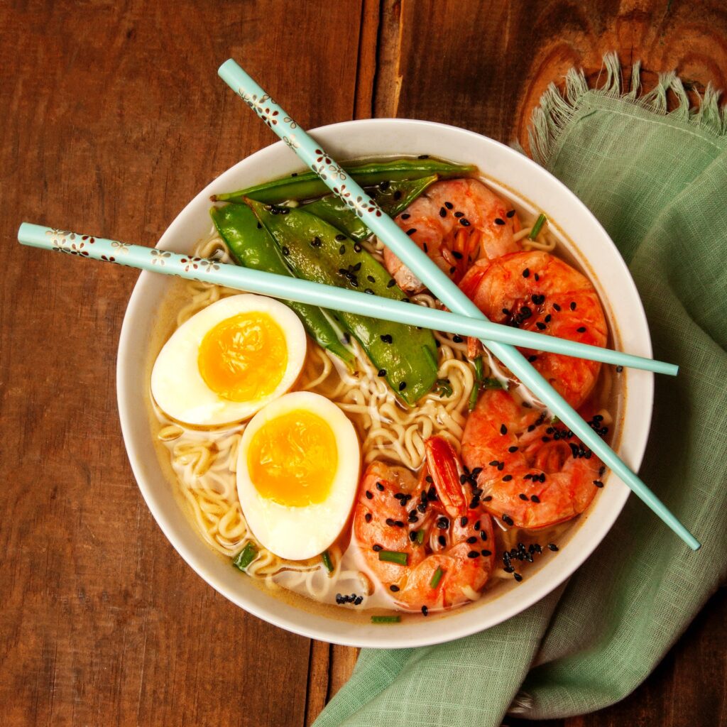 an image of ramen with chopsticks on top of the bowl