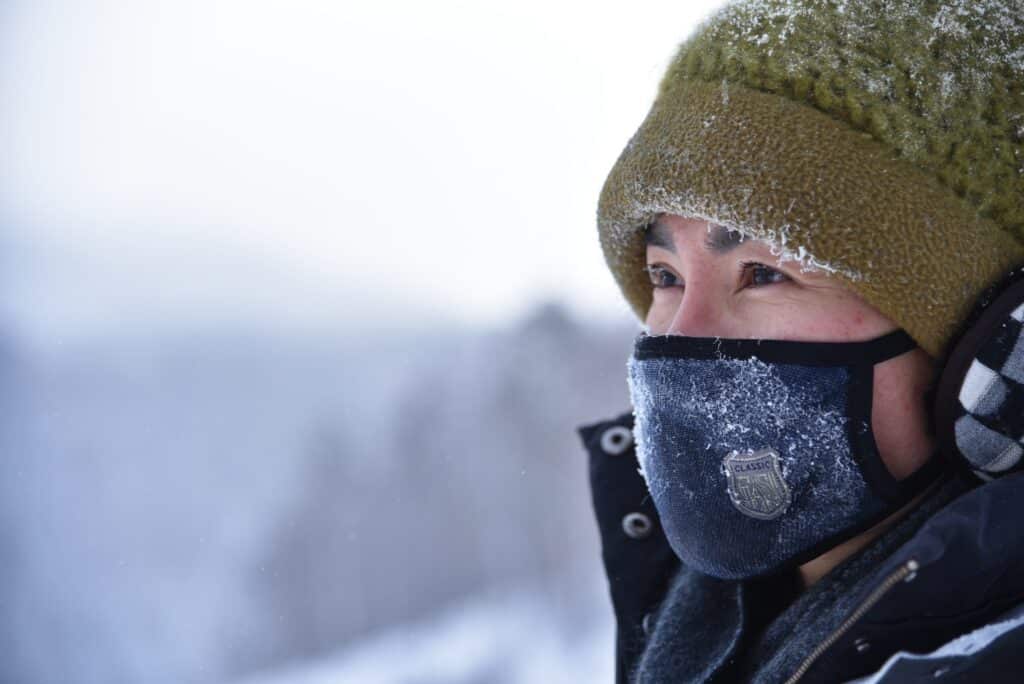 man wearing a hat and mask because of cold weather