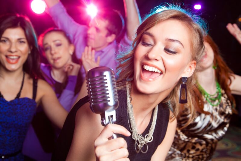 group of young girls singing karaoke