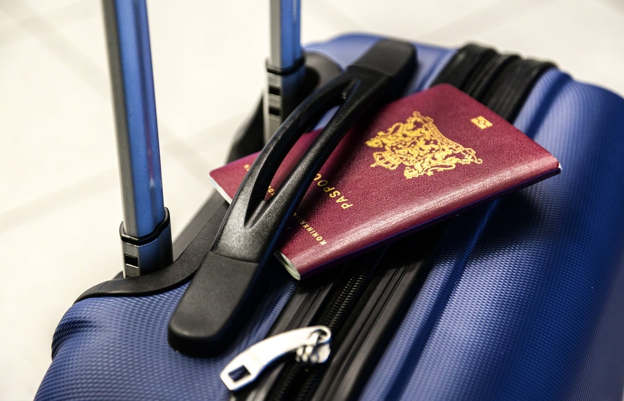 red-passport-tucked-into-baggage-handle