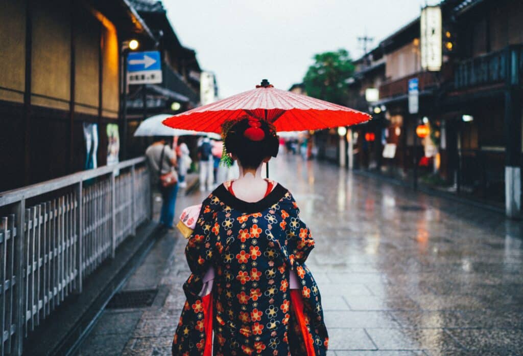 Woman walking down Japanese street in traditional dress
