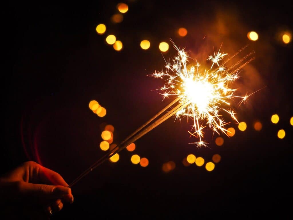 person-holding-lighted-sparkler