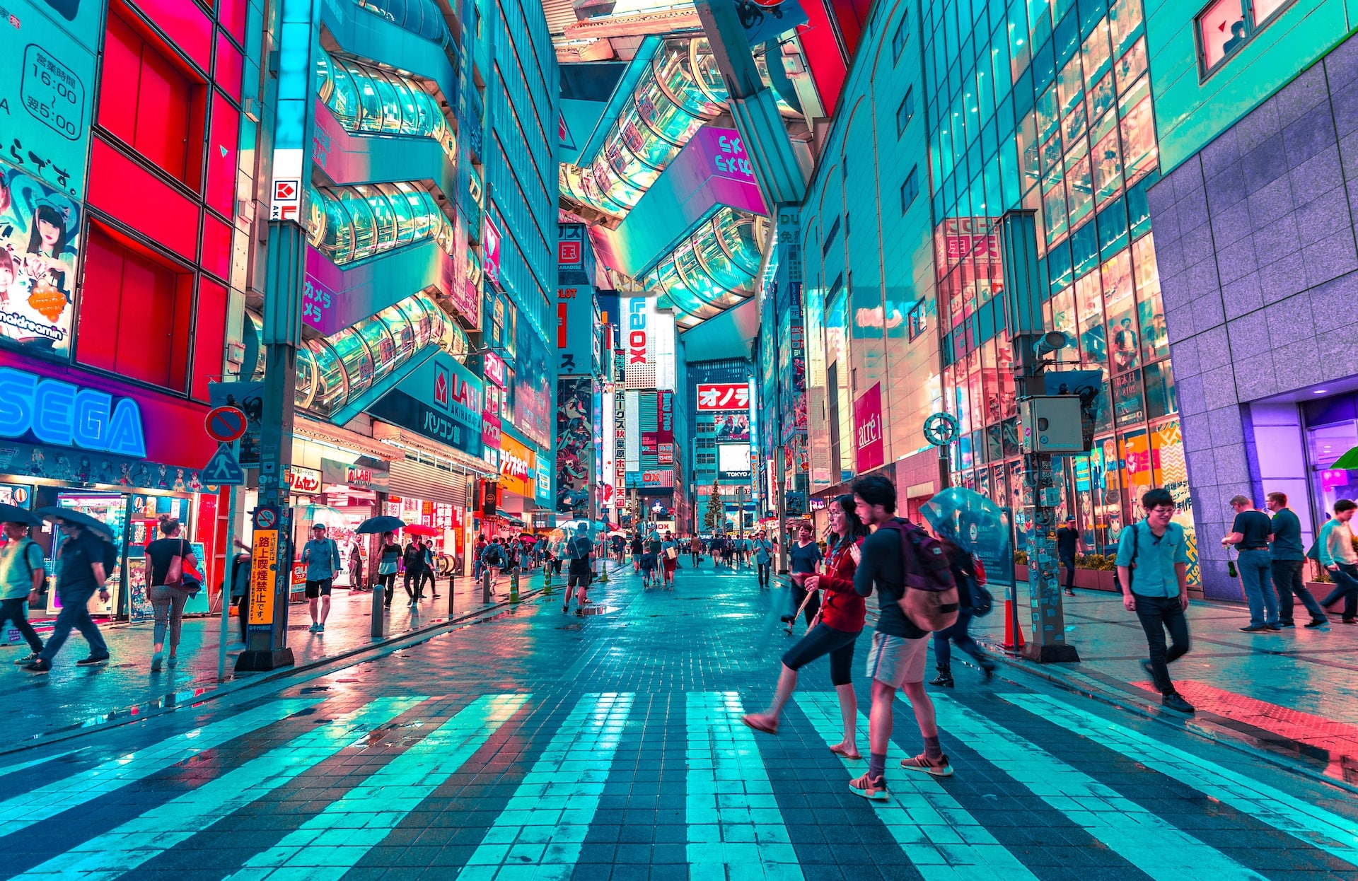 A Tokyo street at night lit up by neon signs