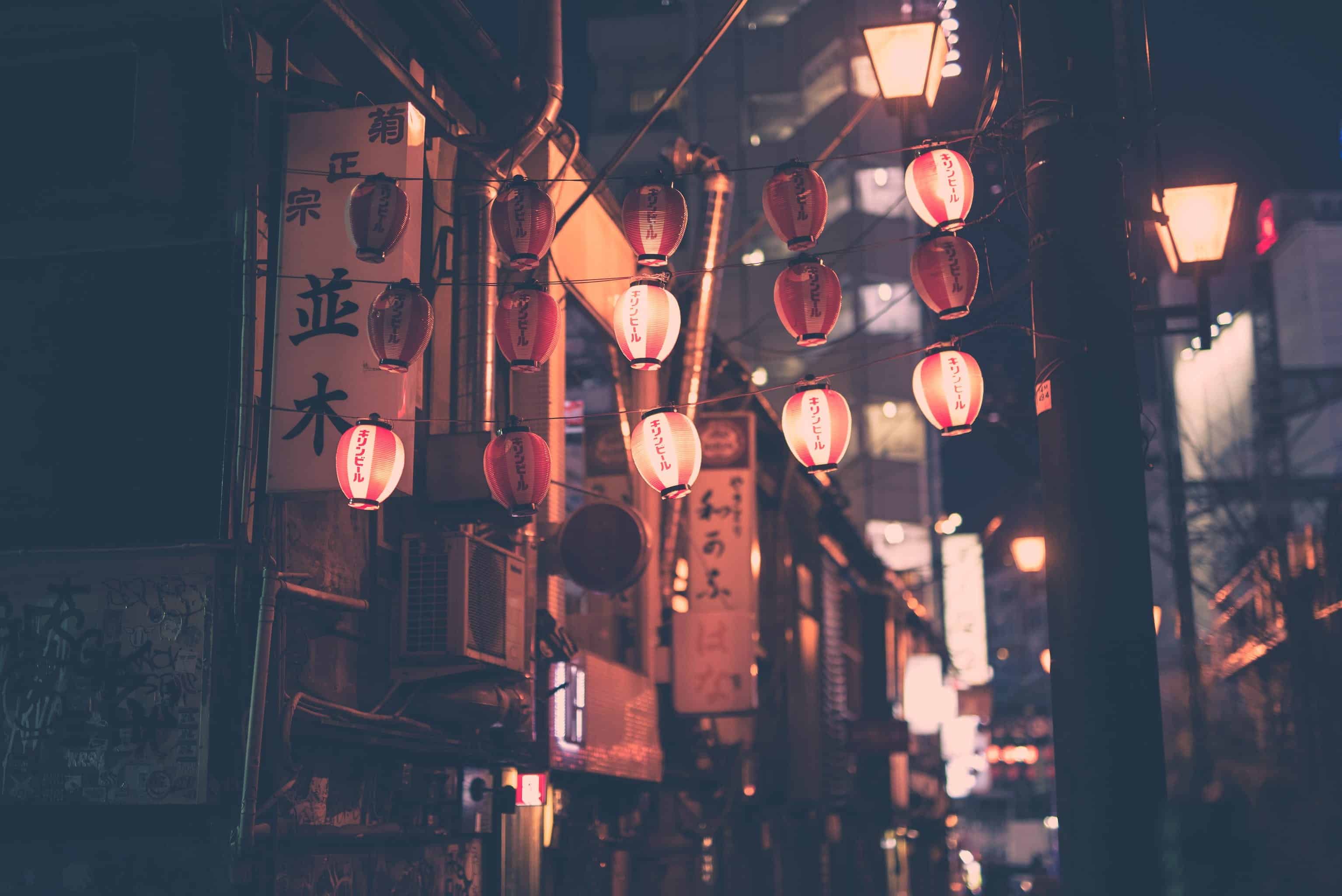 Illuminated Japanese paper lanterns line a street